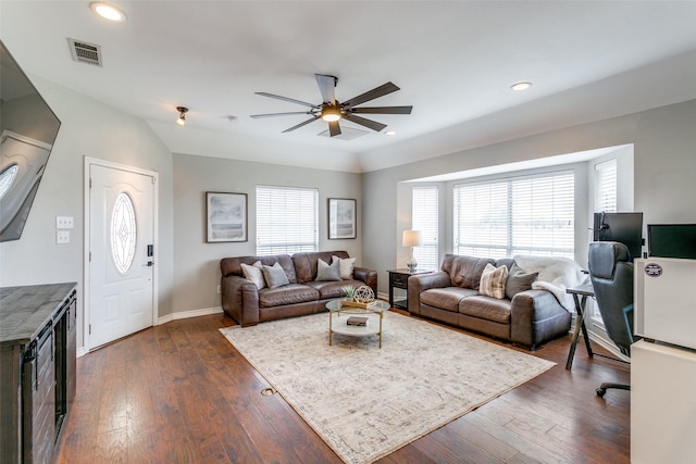 living room featuring plenty of natural light, ceiling fan, and dark hardwood / wood-style flooring