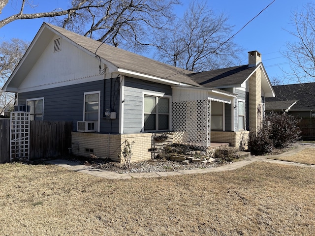 view of side of home with cooling unit and a yard