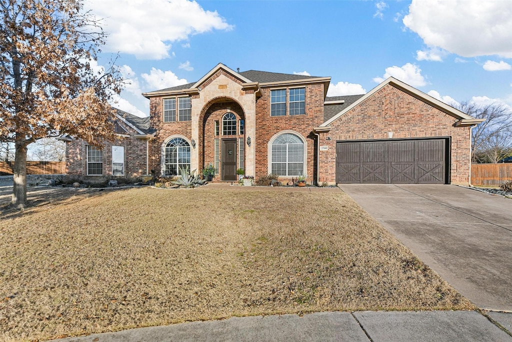 view of property with a garage and a front yard