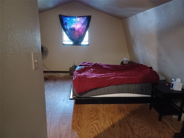 bedroom featuring vaulted ceiling and wood finished floors