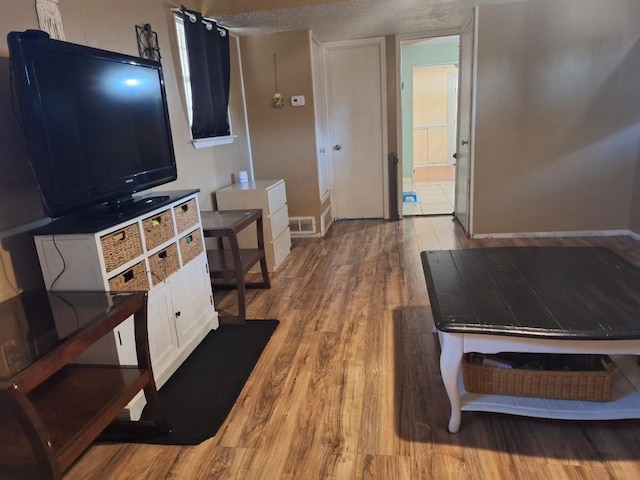 interior space featuring light wood-style floors and visible vents