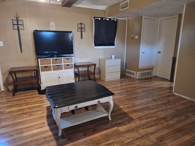 living room featuring a textured ceiling, wood finished floors, and visible vents