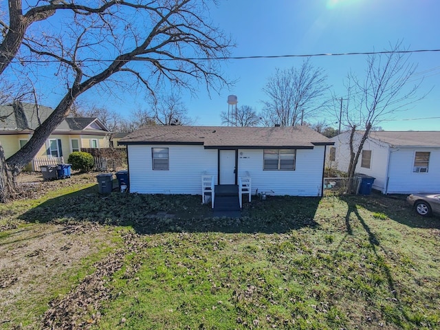 rear view of house with a yard