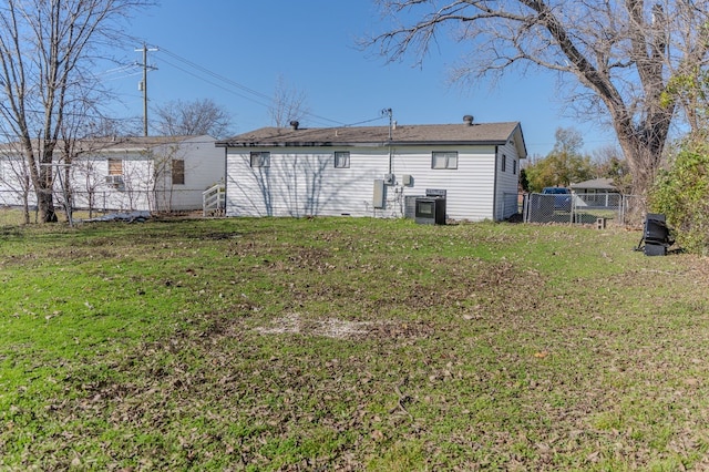 back of property featuring a lawn