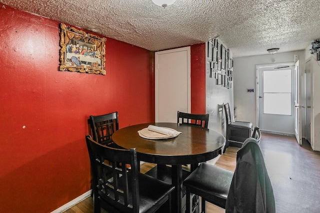 dining space featuring a textured ceiling