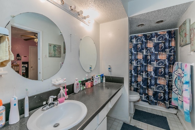 bathroom with ceiling fan, toilet, a textured ceiling, vanity, and a shower with shower curtain