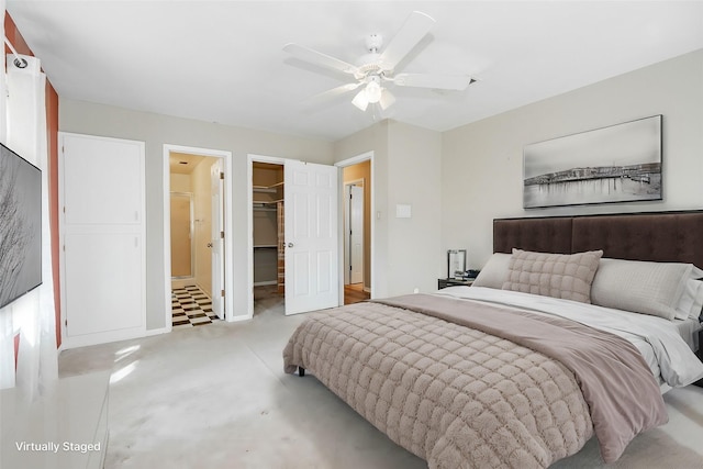 bedroom featuring ceiling fan, connected bathroom, a closet, and a walk in closet