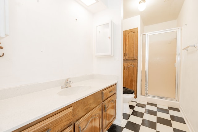 bathroom with a shower with shower door, toilet, and vanity