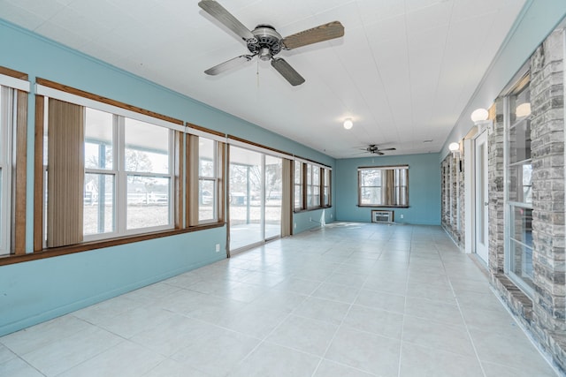 empty room featuring a wall unit AC and ceiling fan