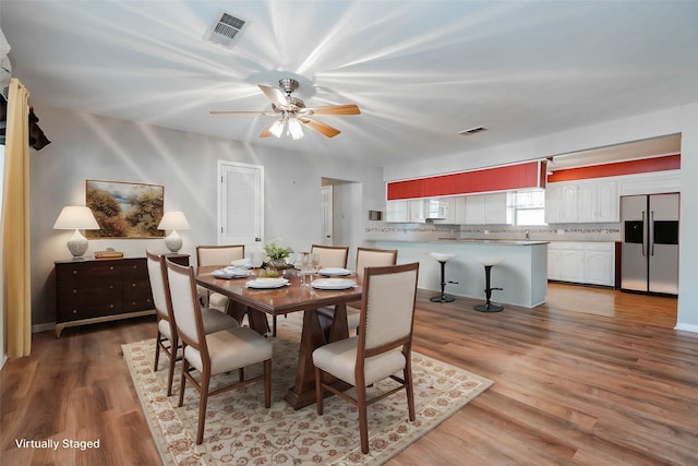 dining room with wood-type flooring and ceiling fan