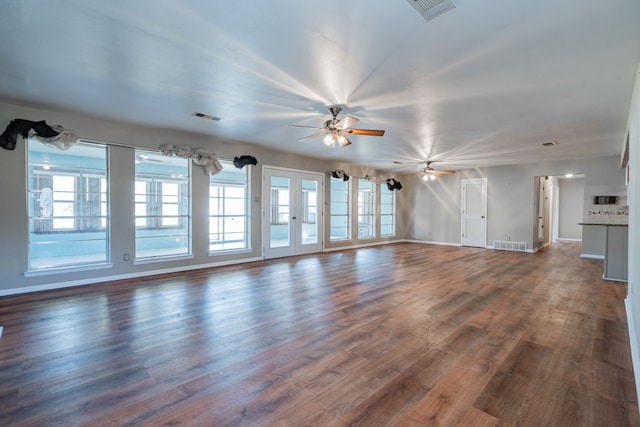 unfurnished living room with ceiling fan and dark wood-type flooring