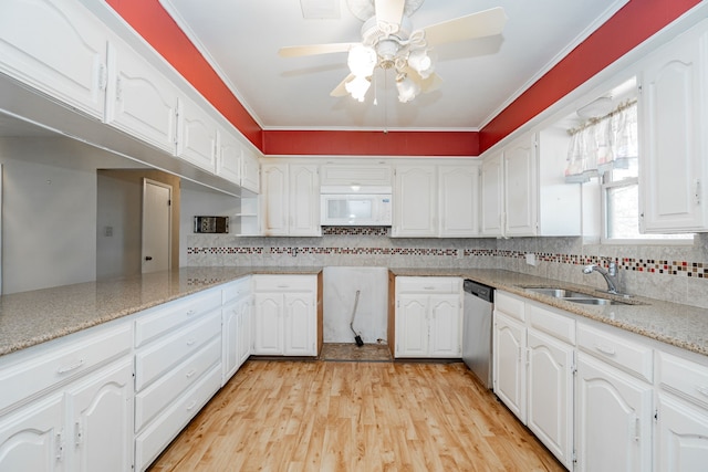 kitchen with sink, white cabinetry, and dishwasher