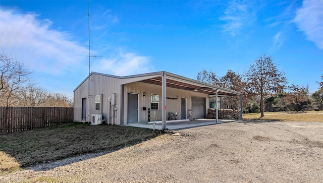 back of property featuring a garage