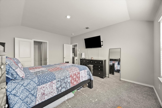 carpeted bedroom with vaulted ceiling