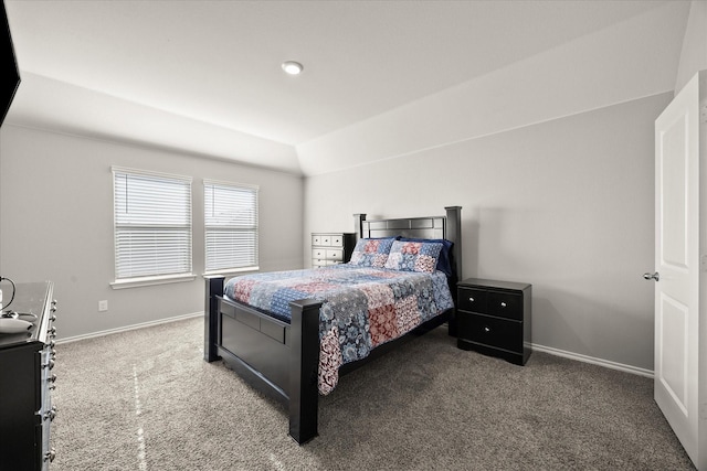 bedroom featuring dark colored carpet and vaulted ceiling