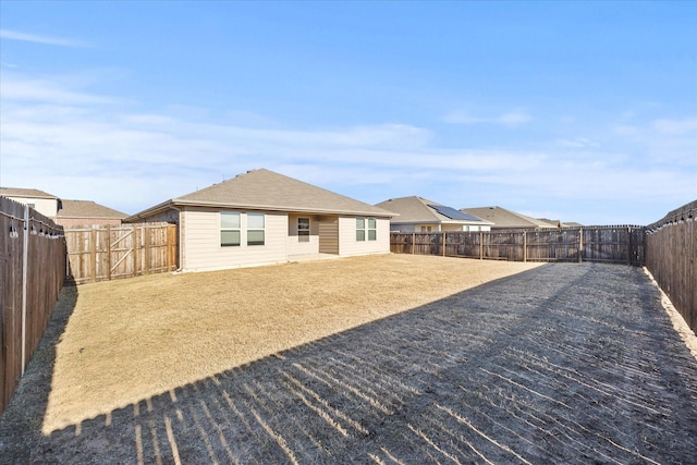 rear view of house with a yard