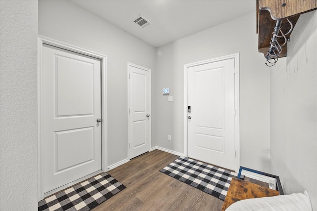 foyer entrance with dark hardwood / wood-style floors