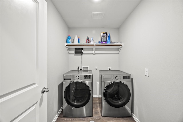 washroom with separate washer and dryer and dark hardwood / wood-style flooring