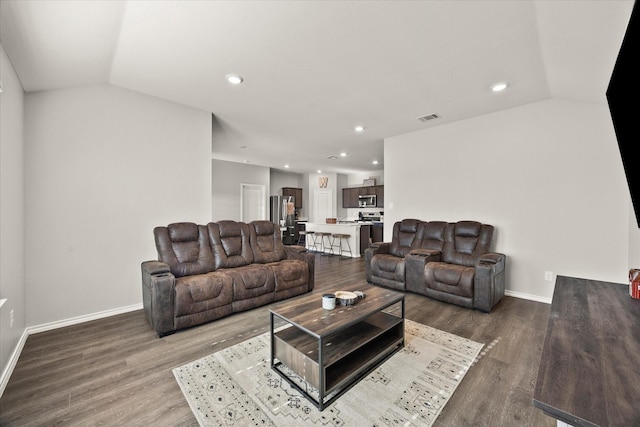 living room featuring vaulted ceiling and wood-type flooring