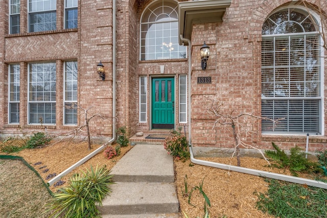 doorway to property with brick siding