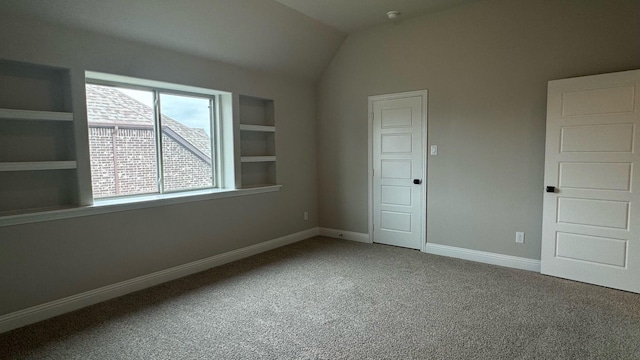 unfurnished bedroom featuring carpet and lofted ceiling