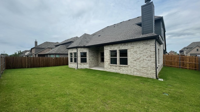 back of property featuring a patio area and a yard