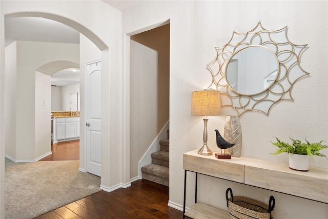 hallway featuring sink and dark wood-type flooring