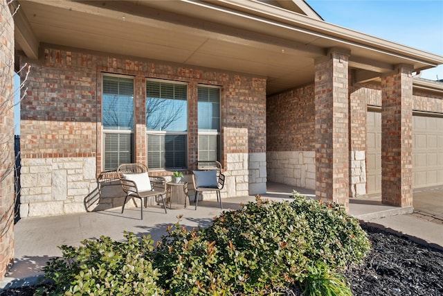 doorway to property featuring a garage and a patio area