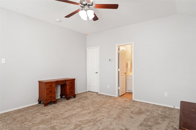 unfurnished bedroom with ceiling fan, connected bathroom, vaulted ceiling, and light carpet