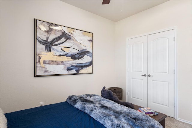 bedroom with ceiling fan, carpet flooring, and a closet