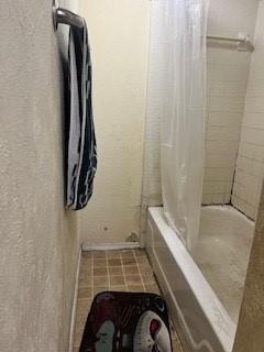 bathroom with shower / bath combination with curtain