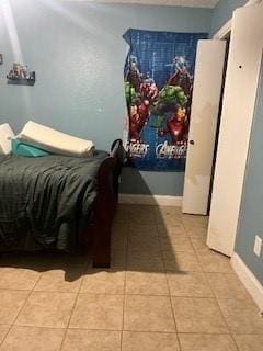 bedroom featuring light tile patterned flooring