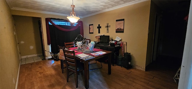 dining area with ornamental molding and hardwood / wood-style floors