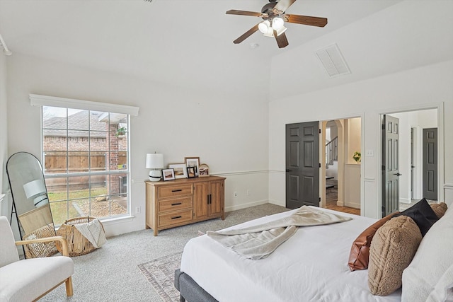 bedroom featuring a ceiling fan, light colored carpet, visible vents, and baseboards