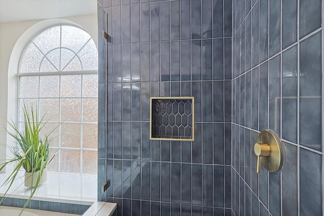 interior details featuring tiled shower