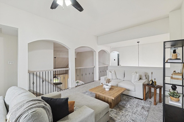 living area with carpet and a ceiling fan