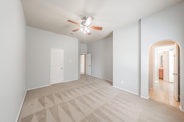 unfurnished room with light colored carpet and ceiling fan