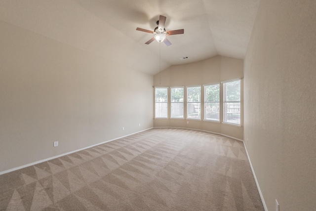 carpeted empty room featuring vaulted ceiling and ceiling fan