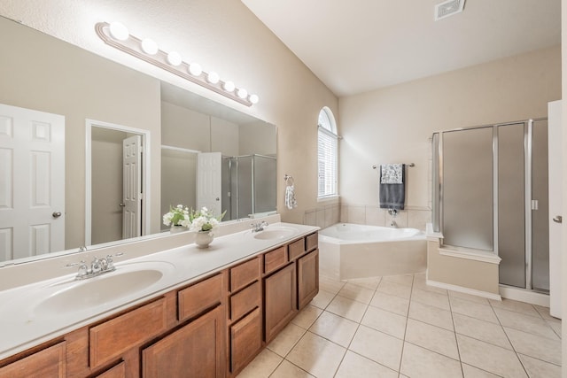 bathroom with tile patterned floors, vanity, and separate shower and tub