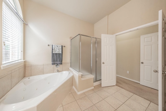 bathroom with tile patterned floors and plus walk in shower