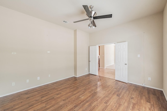 unfurnished room featuring hardwood / wood-style flooring and ceiling fan