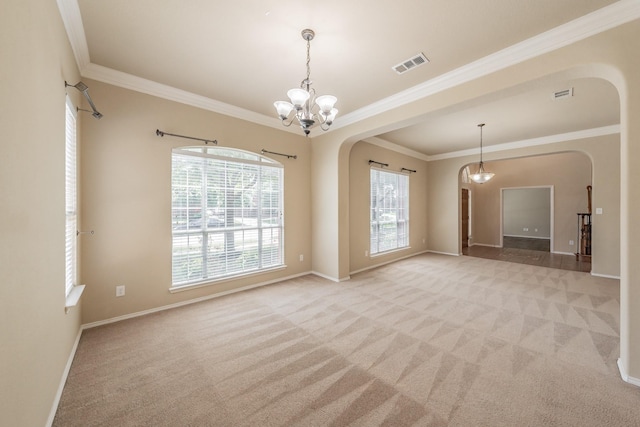 carpeted empty room with a chandelier and crown molding