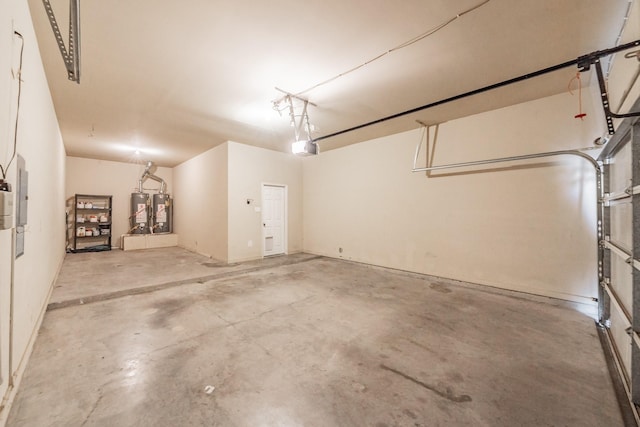 garage featuring a garage door opener and gas water heater