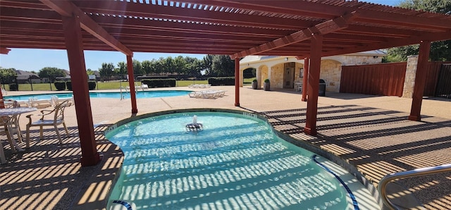 view of swimming pool featuring a patio and a pergola