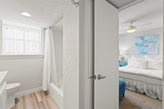 full bathroom with toilet, wood-type flooring, shower / bath combination with curtain, vanity, and ceiling fan