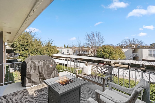 balcony with an outdoor fire pit and grilling area