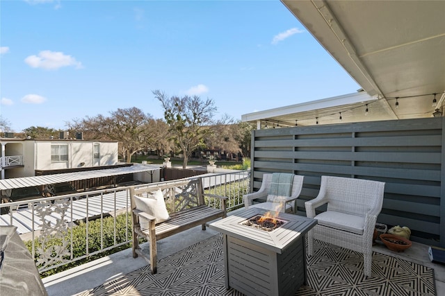 view of patio / terrace with an outdoor fire pit