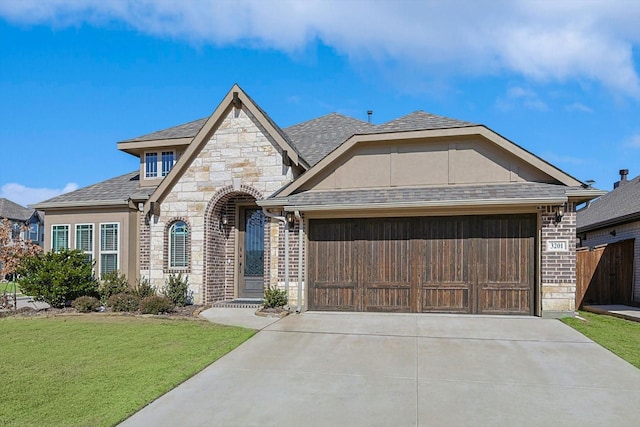 view of front of property featuring a garage and a front yard