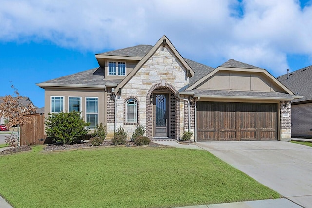 view of front of property featuring a garage and a front lawn