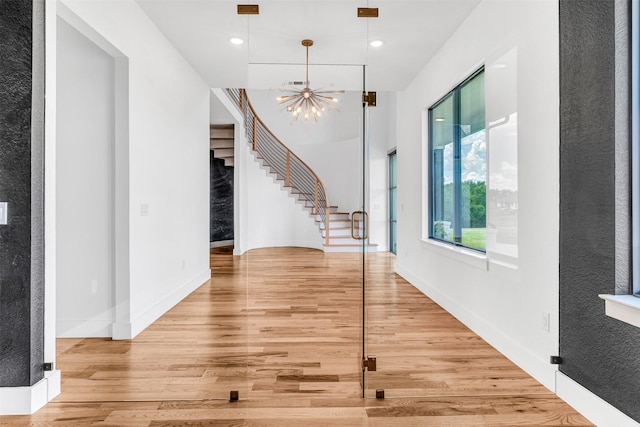 foyer entrance featuring a notable chandelier and hardwood / wood-style floors